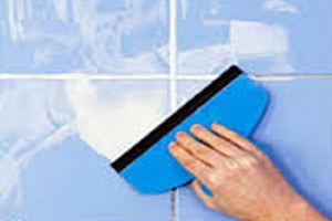 Application-of-grout-with-a-rubber-squeegee-diagonally-across-the-joint